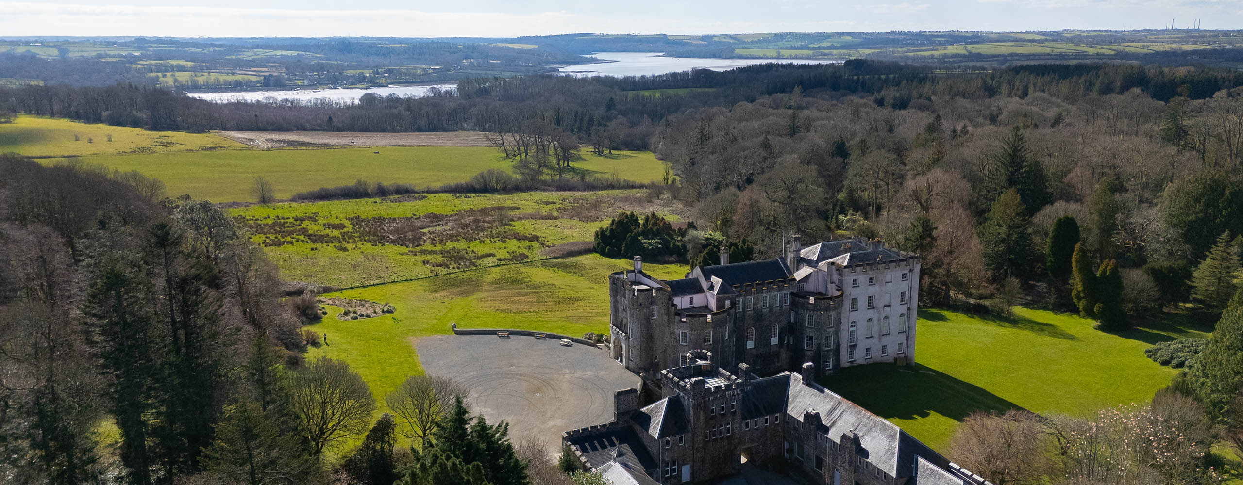A drone shot of Picton Castle in Pembrokeshire, overlooking the estuary.